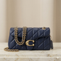 Luxury midnight blue quilted leather shoulder bag with gold chain strap and elegant metal clasp