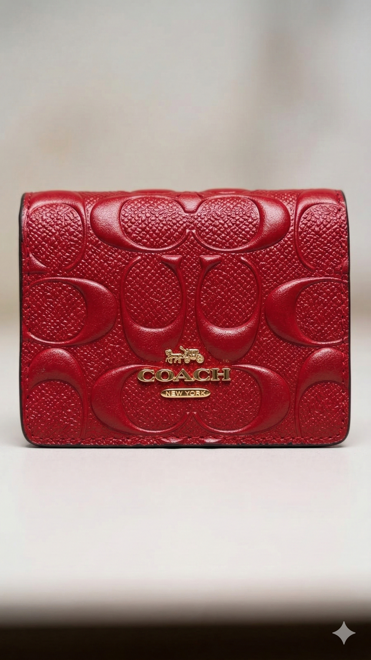 Premium red leather slim wallet with embossed signature design